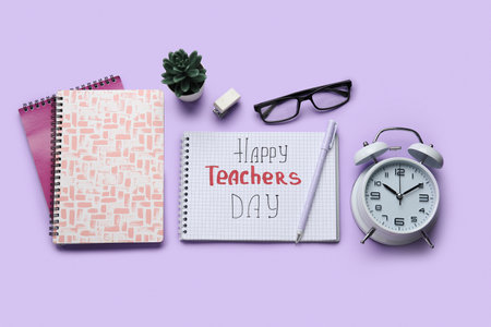 Notebooks with text HAPPY TEACHERS DAY, eyeglasses and alarm clock on lilac backgroundの写真素材