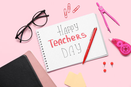 Notebooks with text HAPPY TEACHERS DAY, eyeglasses and different stationery on pink backgroundの写真素材