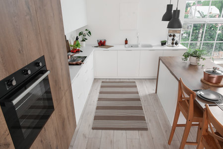 Stylish striped rug in interior of modern kitchenの写真素材