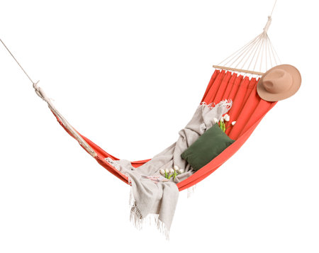 Cozy red hammock with cushions, plaid and hat isolated on white backgroundの写真素材