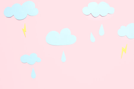 Paper clouds with raindrops and lightnings on pink background. weather forecast concept