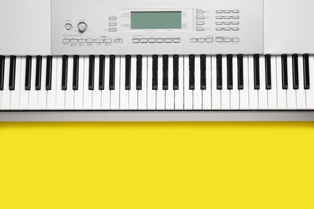 Modern synthesizer keyboard on yellow backgroundの写真素材