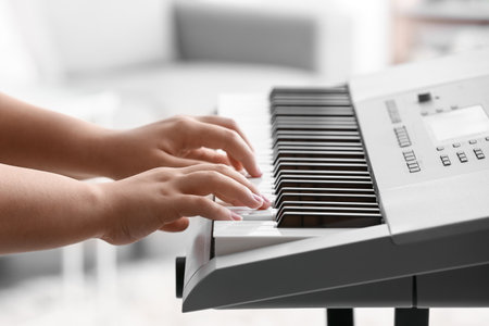 Woman playing modern synthesizer, closeupの写真素材