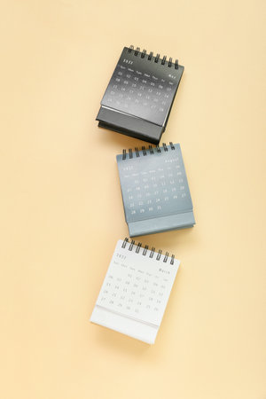 Flip paper calendars on beige backgroundの写真素材