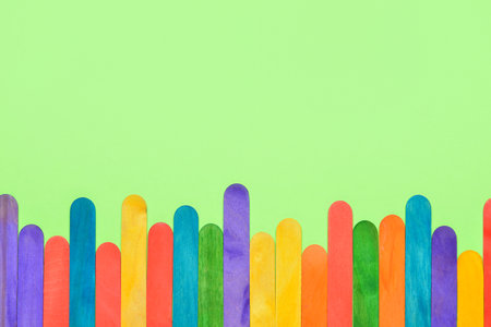 Colorful ice cream sticks on green backgroundの写真素材