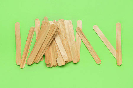 Ice cream sticks on green backgroundの写真素材