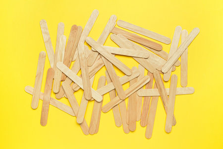 Ice cream sticks on yellow backgroundの写真素材