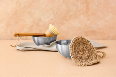 Bowl and natural household sponge on beige backgroundの写真素材