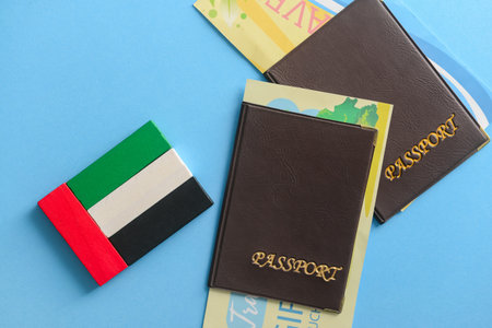 UAE flag made of blocks and passports on blue background