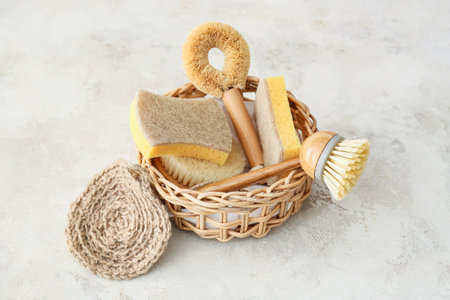 Basket with natural cleaning supplies on light backgroundの写真素材