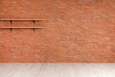 Empty shelves hanging on brick wallの写真素材