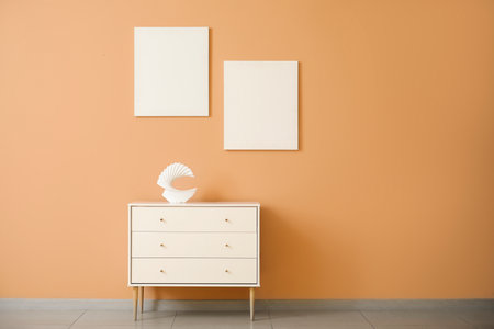 Stylish chest of drawers near color wallの写真素材