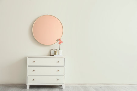 Interior of room with mirror and chest of drawersの写真素材