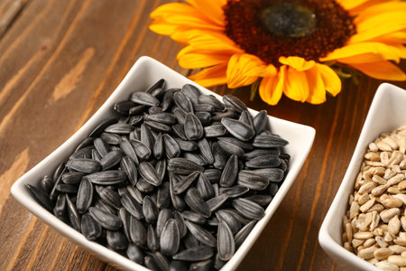 Bowls with sunflower seeds on wooden backgroundの写真素材