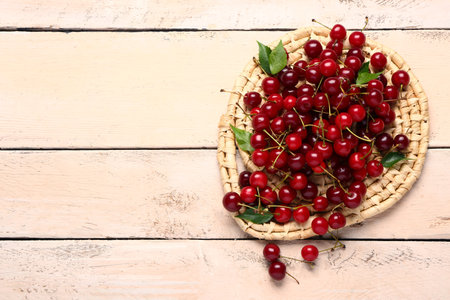 Heap of red sweet cherry on white wooden backgroundの写真素材