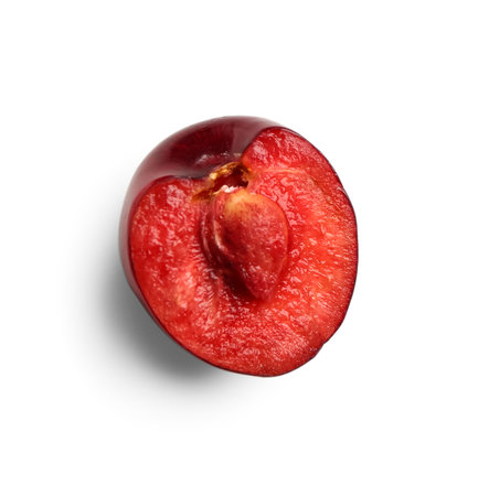 Half of red sweet cherry on white backgroundの写真素材