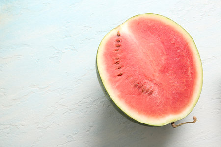 Half of fresh watermelon on light blue backgroundの写真素材