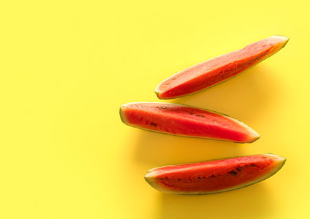 Pieces of fresh watermelon on yellow backgroundの写真素材