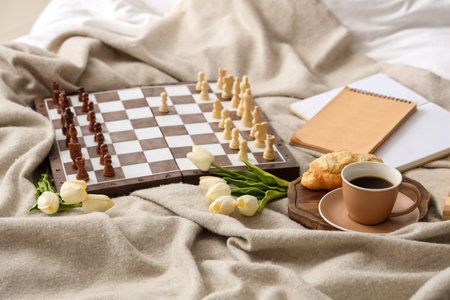 Chess board with breakfast and tulips on plaidの写真素材