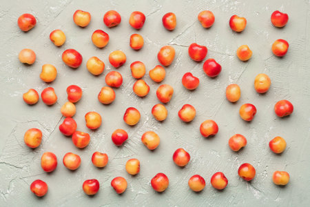 Many sweet yellow cherries on gray backgroundの写真素材