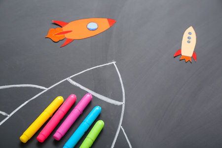 Drawn and paper rockets with markers on black backgroundの写真素材
