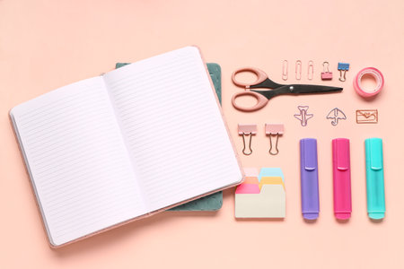 Different school stationery and blank notebook on pink backgroundの写真素材