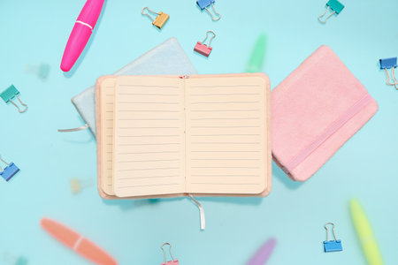 Blank notebook with stationery on blue backgroundの写真素材