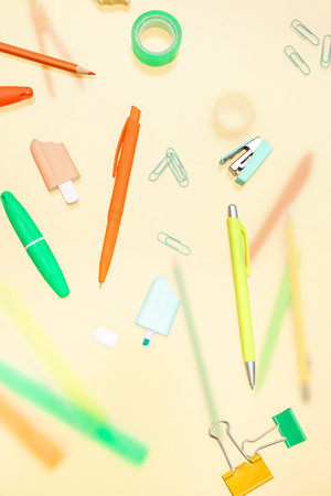 Different stationery on pale yellow background