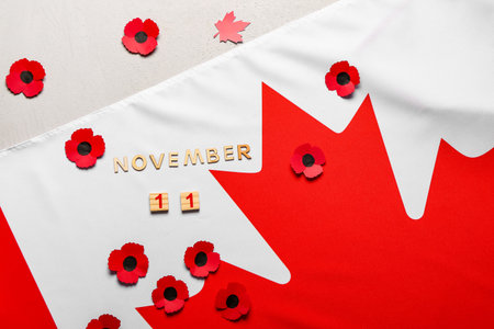 Poppy flowers with flag of Canada and text 11 NOVEMBER on white background. Remembrance Day