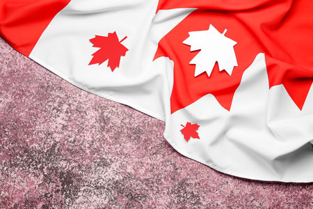 Flag of Canada and paper maple leaves on purple backgroundの写真素材