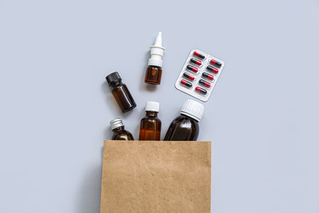 Shopping bag with different medicines on gray backgroundの写真素材