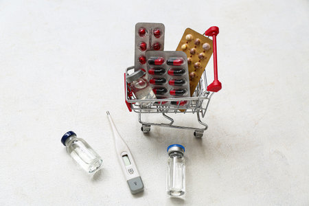 Mini shopping cart with different pills on white backgroundの写真素材