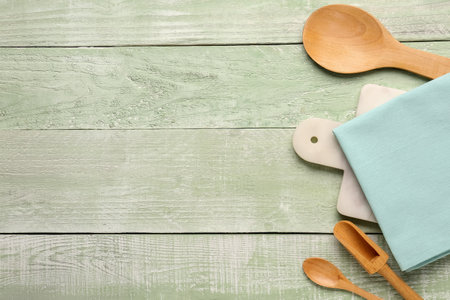 Composition with kitchen utensils and clean napkin on color wooden backgroundの写真素材