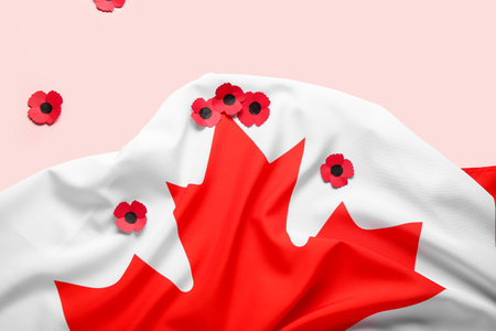Poppy flowers with flag of Canada on pink background. Remembrance Dayの写真素材