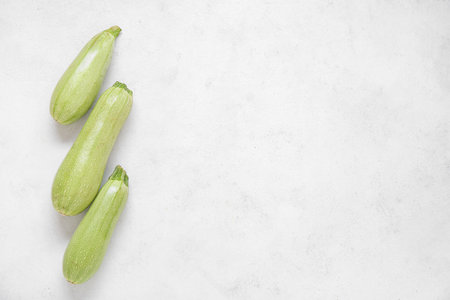 Fresh green zucchini on light backgroundの写真素材