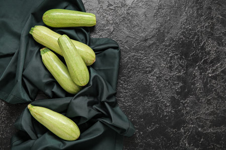 Fresh green zucchini on black backgroundの写真素材