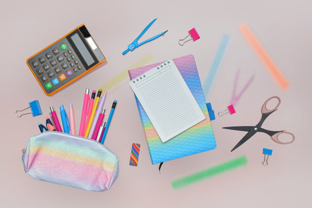 Composition with blank notebook and school stationery on pink background