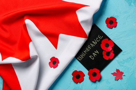 Poppy flowers with flag of Canada and card on blue background. Remembrance Dayの写真素材