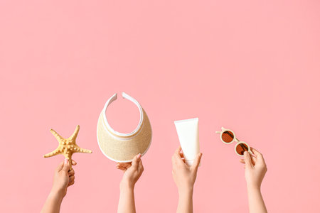 Many hands with beach accessories on pink backgroundの写真素材