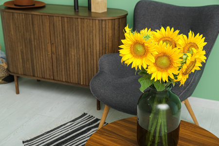 Vase with sunflowers on table in living room, closeupの写真素材