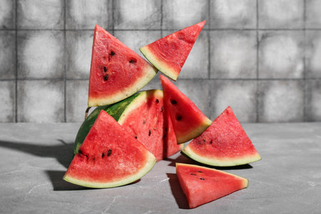 Pieces of fresh watermelon on gray tableの写真素材