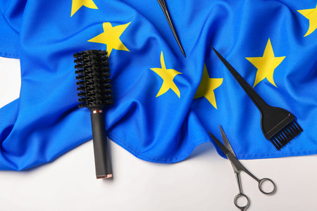Flag of European Union with hairdresser tools on white backgroundの写真素材