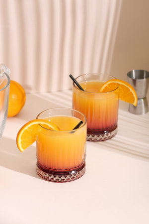 Glasses of tasty mai tai cocktail on light background