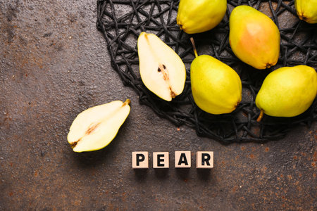 Word PEAR and fresh fruits on dark backgroundの写真素材