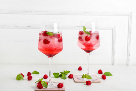 Glasses of fresh raspberry mojito on white backgroundの写真素材