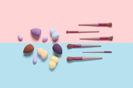 Makeup sponges and brushes on colorful background