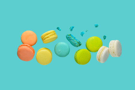 Flying sweet macaroons on blue backgroundの写真素材