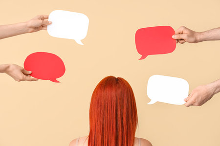 Woman and different hands with speech bubbles on beige backgroundの写真素材