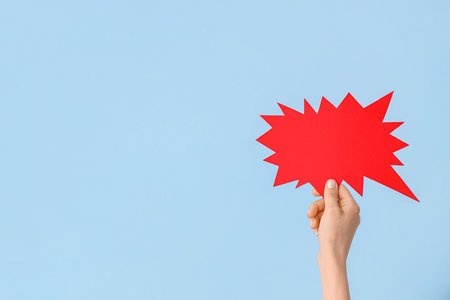 Female hand with speech bubble on blue background