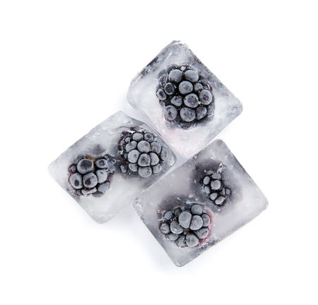 Frozen blackberries in ice cubes on white backgroundの写真素材